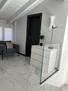 a living room with a dresser and a mirror at PAGANINI suits and apartments in Sirmione