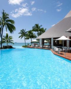 a large swimming pool in front of a resort at Lagoon Beachfront Lodge 202 on Hamilton Island by HamoRent in Hamilton Island