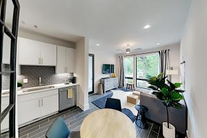 a kitchen and living room with a table and chairs at 19th & Wedgewood in Nashville