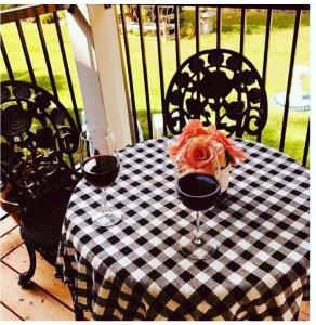 a black and white checkered table with two glasses of wine at Country Dream in Fintry