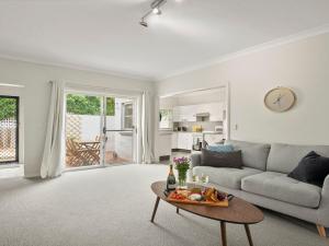 a living room with a couch and a table at Finchs Nest in Moss Vale