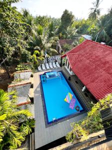 an overhead view of a swimming pool with a red roof at Bora Bora Amore Villa in Hikkaduwa