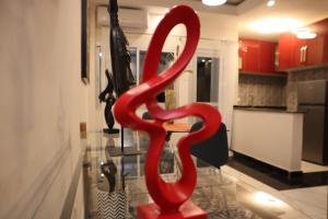 a large red sculpture in the middle of a room at Résidence L'écrin in Yaoundé