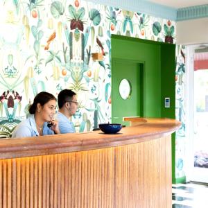 a man and a woman sitting at a bar at The Continental Hotel in Broome +84 photos