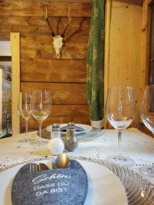 uma mesa com copos de vinho e um crânio na parede em Kaiserhaus Harald Astner Ebbs Studio 2 em Ebbs