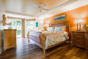 a bedroom with a bed and a ceiling fan at Villas of Kamali'i 56 condo in Princeville +34 photos