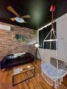 a living room with a couch and a swing at La suite Grenoble spa jacuzzi et sauna privatif in Grenoble +22 photos