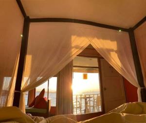 a bedroom with a window with a view of the ocean at Lareena Resort Koh Larn Pattaya in Ko Larn