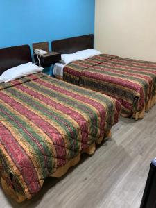Postel nebo postele na pokoji v ubytování Royal Relax Inn
