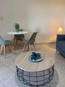 a living room with a coffee table and chairs at ATHINAS APARTMENT in Limenas