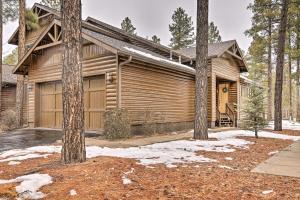 a log cabin with a garage in the woods at Deck and Gas Grill Spacious Pinetop Cabin in Indian Pine