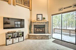 a living room with a fireplace and a tv at Deck and Gas Grill Spacious Pinetop Cabin in Indian Pine