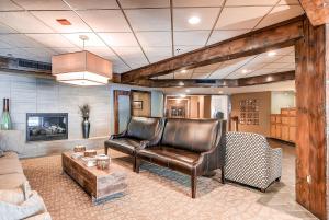 a living room with two leather chairs and a table at Studio Condo 4313 at the Village at Breckenridge in Breckenridge