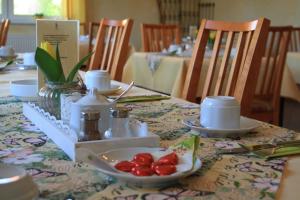 a table with a plate of fruit on it at Hotel zum Ritter Nidderau in Nidderau