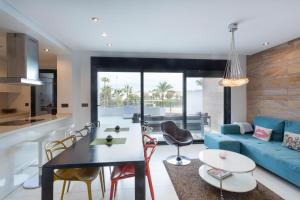 a kitchen and living room with a blue couch at Apartment in Mil Palmeras in Pilar de la Horadada