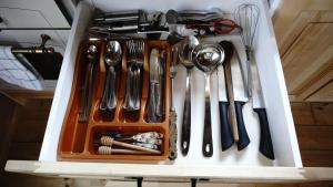 a drawer filled with utensils and utensils at house s&d in Otočac