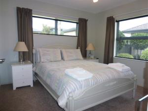 a bedroom with a bed with two towels on it at Aquila Haven in Whitianga