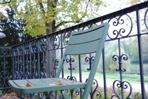 a blue chair sitting in front of a fence at Wassergasse 11 in Regensburg