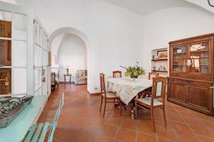 a kitchen and dining room with a table and chairs at Residenza Stoechas White in Albenga