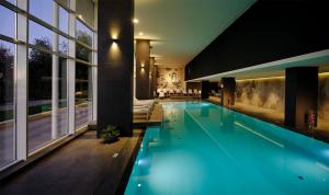 a swimming pool in a house with blue lights at Hotel Ambasador - Liburnia in Opatija