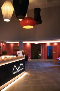 a lobby with a hotel cost wrap sign and lights at Hotel Casa Alpina in Folgaria