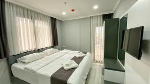 A bed or beds in a room at Heaven Suite Hotel Még 31 kép