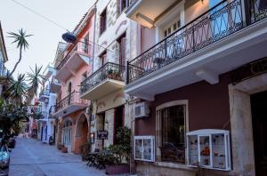 a street in a town with pink and white buildings at Consolato Boutique in Chania Town