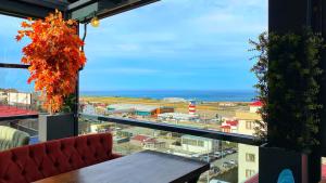 a balcony with a table and a view of a city at Heaven Suite Hotel in Trabzon