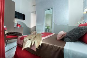 a bedroom with two beds with red and white at Demetra Hotel in Rome