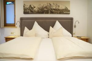 1 dormitorio con 1 cama con almohadas blancas en Hirzinger Marlis en Going