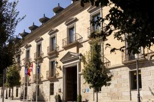 a building with two flags in front of it at Parador de La Granja in La Granja de San Ildefonso