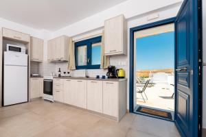 a kitchen with a door open to a patio at Villa Waves in Monolithos