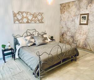 a bedroom with a bed with a metal frame at Lovely 2 bedroom apartment steps from Ascoli's stunning Piazza del Popolo in Ascoli Piceno