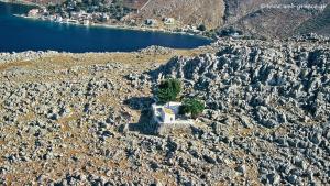 a small house on a rocky hillside near the water at Symi . VILLA CALME (Sur la Mer). in Symi