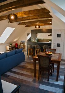 a living room with a blue couch and a table at Apartman Vulcano in Zvolen