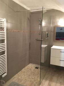 a shower with a glass door in a bathroom at Casa Natalina de caractère entièrement rénovée classée 4 étoiles in Feliceto