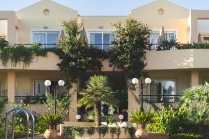 a building with plants on the side of it at Helios Apartments in Kato Daratso