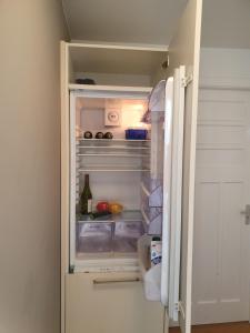 a refrigerator with its door open with food inside at Bed zonder Breakfast in Amsterdam