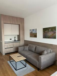 a living room with a couch and a table at Apartmani G8 in Pale