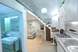 a kitchen with a sink and a staircase in a room at Little Dream in Piano di Sorrento +7 photos