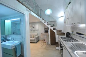 a kitchen with a staircase leading to a living room at Little Dream in Piano di Sorrento