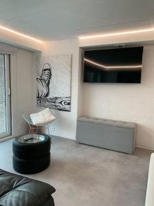 a living room with a couch and a tv at PARK Loft @ BRUGES with private (free) parking in Bruges