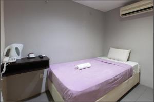 Postel nebo postele na pokoji v ubytování T-Hotel Bukit Bintang