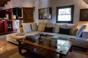 a living room with a couch and a coffee table at Can Barrina in Montseny