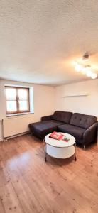 a living room with a couch and a coffee table at Ferienwohnung in Nesselwang, Allgäu Bergfreunde in Nesselwang