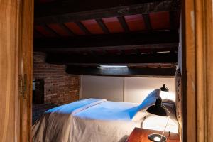 a bedroom with a bed and a desk with a lamp at Can Barrina in Montseny