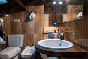 a bathroom with a white toilet and a sink and a toilet at Can Barrina in Montseny