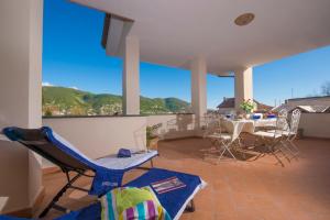 a living room with chairs and a table with a view at Casa Olimpo in Agerola