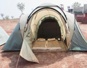 a tent with two beds inside of it at StayApart - Deccan Trails Vikarabad in Vikārābād