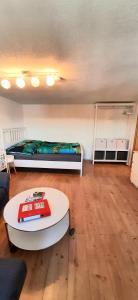 a living room with a bed and a coffee table at Ferienwohnung in Nesselwang, Allgäu Bergfreunde in Nesselwang